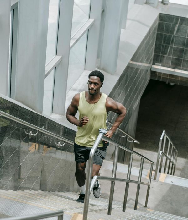 Man performing a controlled strength exercise in a bright room.
